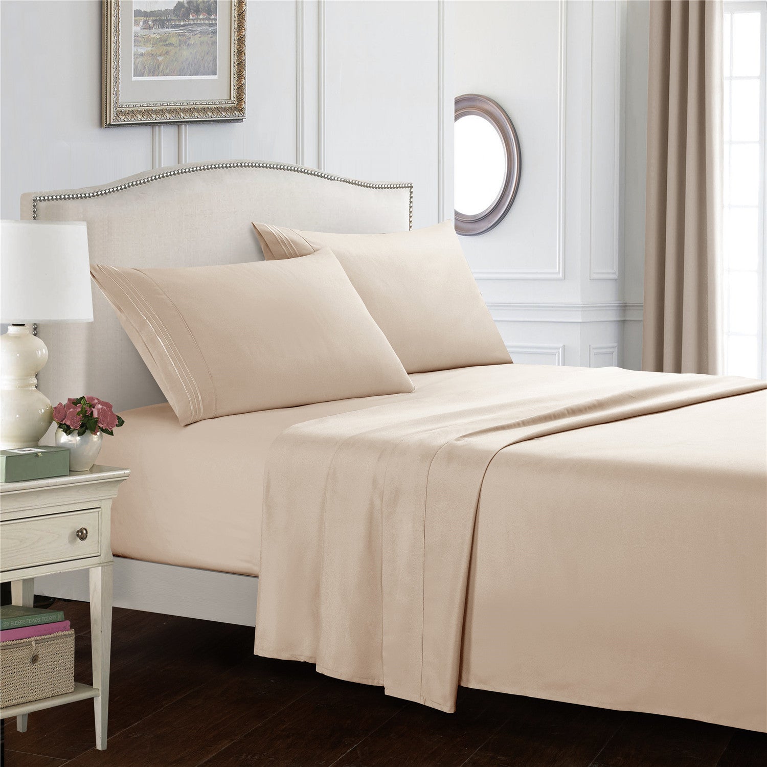 Beige bed sheets and pillows on a neatly made bed in a bedroom setting.