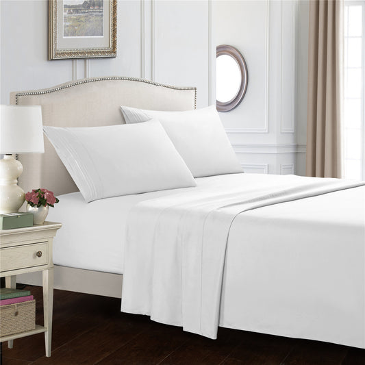 White bed sheets styled on bed with modern bedroom decor